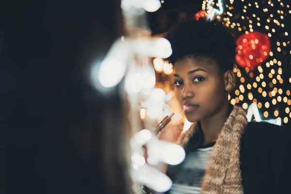 Vaping girl on night city street — Stock Photo, Image