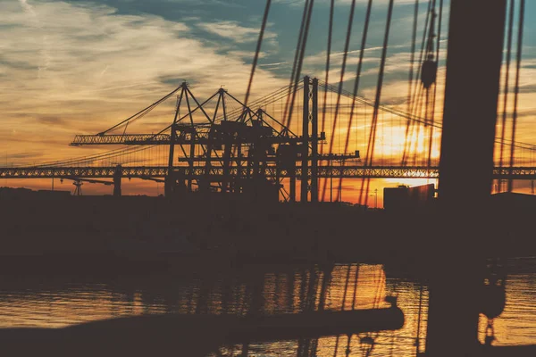 Port in Lisbon and rope bridge on sunset — Stock Photo, Image