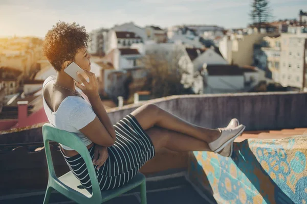 Brazilian girl phoning on roof in Lisbon — Stock Photo, Image