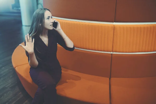 Business lady phoning in office chillout zone