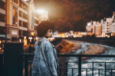 Black girl on bridge in evening clipart
