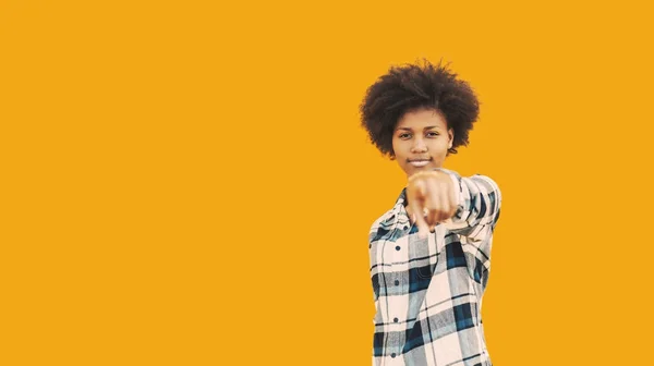 African american hipster girl on yellow background