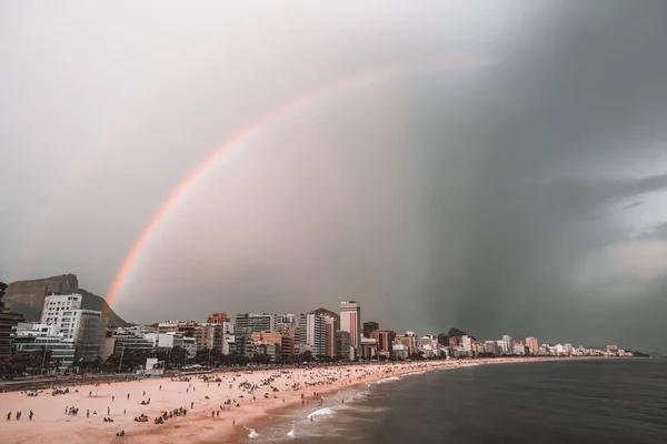 Stormy sky with rainbow over beach in Rio de Janeiro