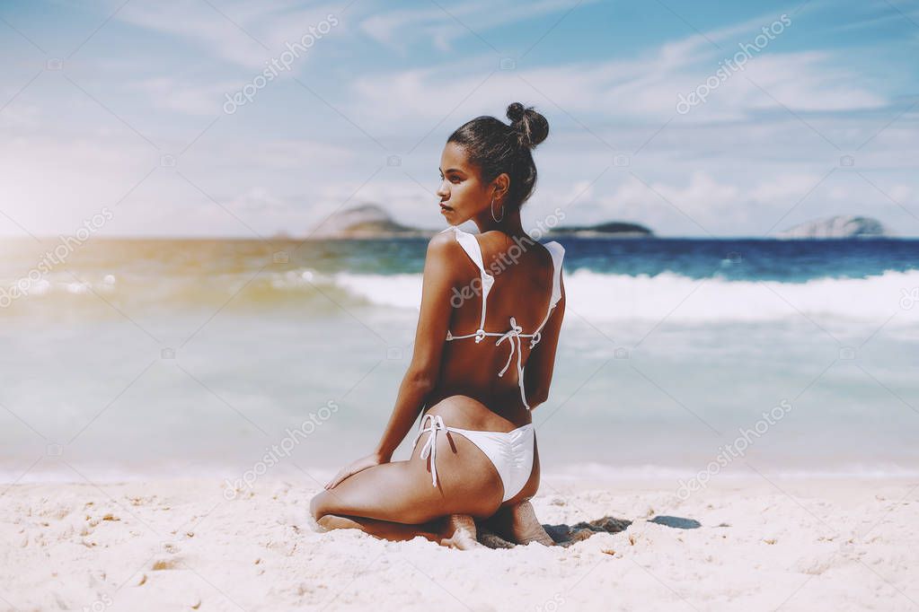 Black young model girl in swimsuit on the beach