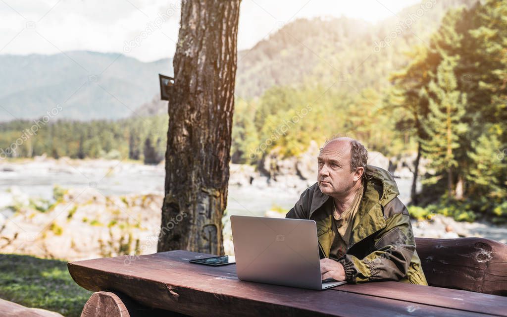 Male forester with his laptop outdoors