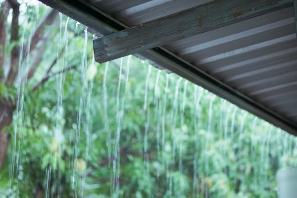 Rain drops fast dipping from zinc roof — Stock Photo, Image