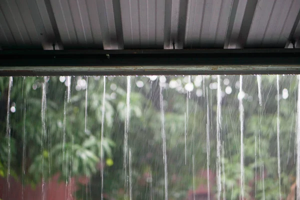 Rain drops fast dipping from zinc roof — Stock Photo, Image