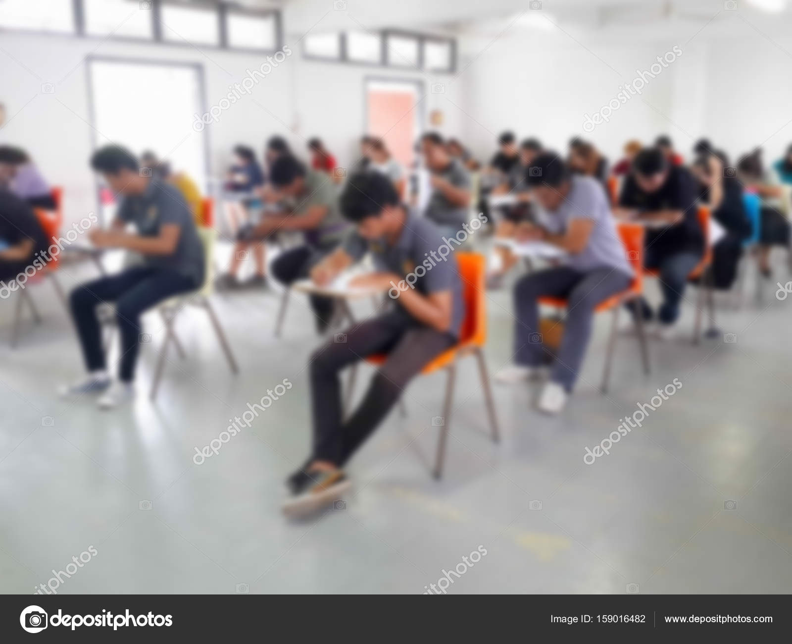 Blur students writing answer doing exam in classroom Stock Photo by ©lekcha  159016482