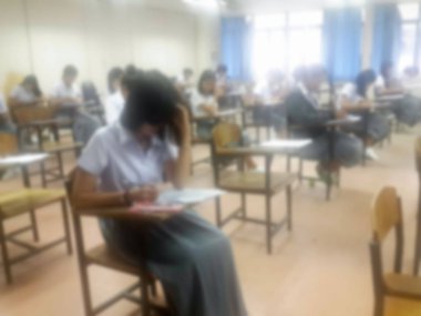 Arka plan üniversite öğrencilerinin sınav yaparak cevap yazma bulanıklık