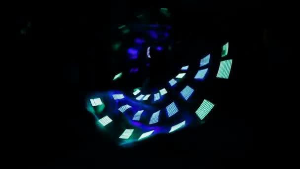 La fille danse une danse papillon cool dans un costume fluorescent avec des ampoules 