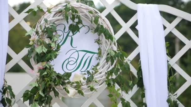 Wedding decorations with flowers, hearts, butterflies. Wedding ceremony. Two letters K and T — Stock Video