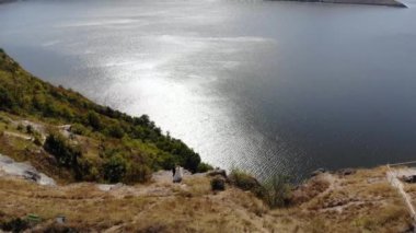 Dinyester Kanyonu, River ve Bakota Körfezi 'nin muhteşem hava manzarası. Dağlarda yürüyen bir çift. 4K