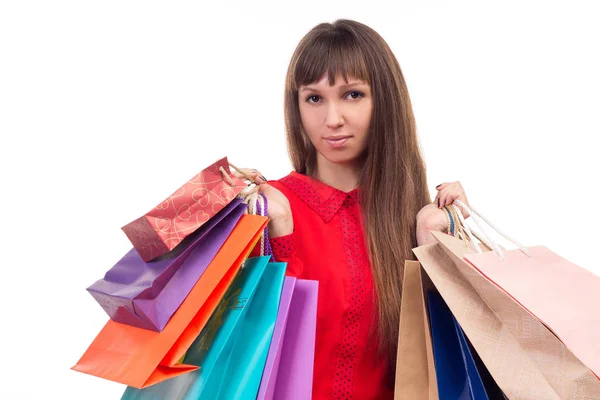 Jovem de cabelos longos mulher realiza compras, muitos multicolo — Fotografia de Stock