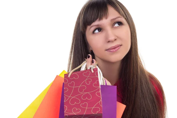 Nahaufnahme eines lächelnden Mädchens mit bunten Einkaufstüten aus Papier — Stockfoto