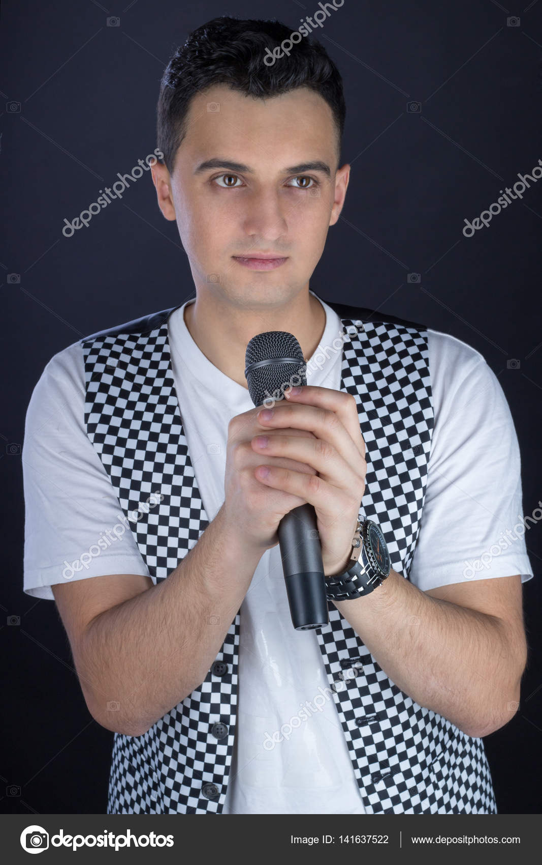 Young Male Black Haired Rock Singer Performs Singing To Micropho
