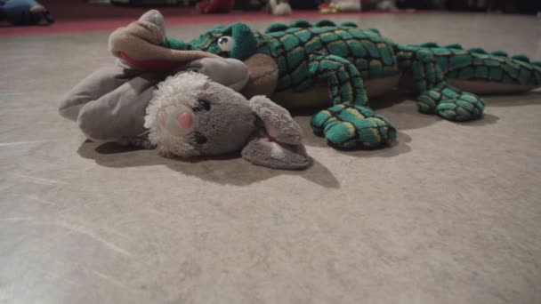 Plush crocodile eats the rabbit toy — Stock Video