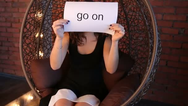 Young girl shows the inscription: "go on" — Stock Video