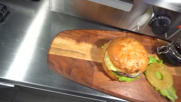 Leckere Burger mit Käse, Salat, Zwiebeln, Tomaten und Ananas. — Stockvideo