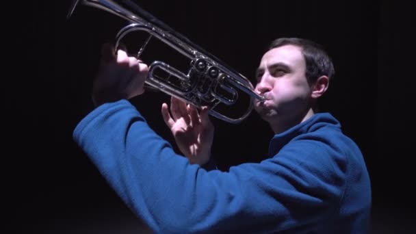 En musiker spelar trumpet, isolerad svart bakgrund — Stockvideo