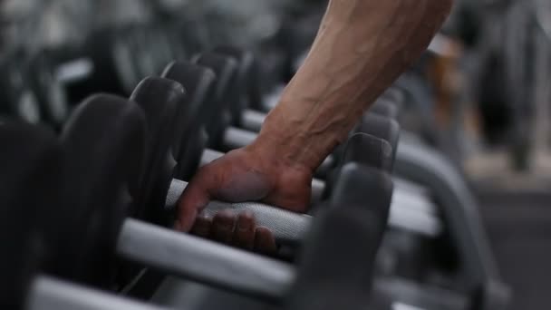 Bodybuilder takes the dumbbell. — Stock Video