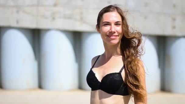 Young brown hair woman in a black bra smiling and showing a sign of ok in summer day — Stock Video