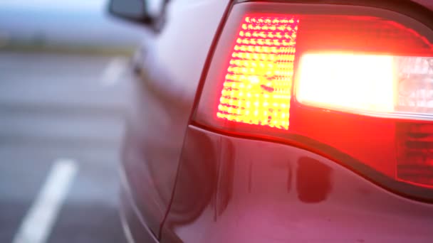 Turn signal light blinking on red car, traffic signalization — Stock Video