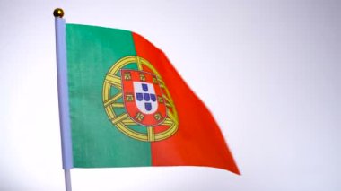 Bayrak direğinde Portekiz bayrağı dalgalanıyor ve rüzgarda sallanıyor.