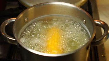 Ear of corn are cooked in a saucepan. Healthy diet. Fitness diet. For a sweet treat.