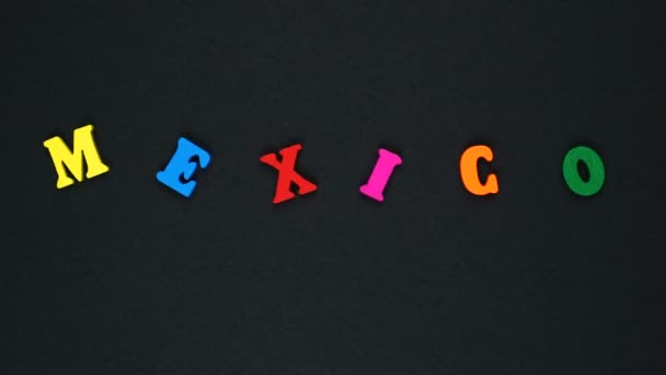 Word "Mexico" formed of wooden multicolored letters. Colorful words loop. — Stok video