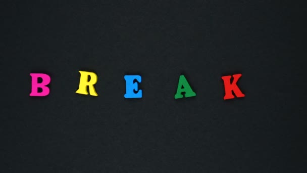 Word "break" formed of wooden multicolored letters. Colorful words loop. — Stok video