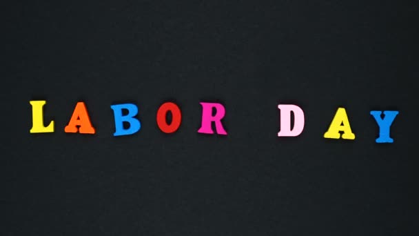 Word "labor day" formed of wooden multicolored letters. Colorful words loop. — Αρχείο Βίντεο