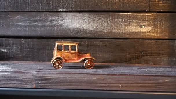 Olden figurine of a car on a wooden background. Minimalism. — Stock Video