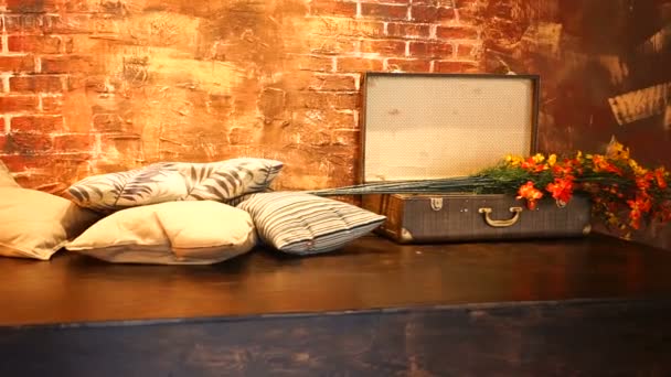 Arrangement of flowers, pillows and suitcase — Stock Video