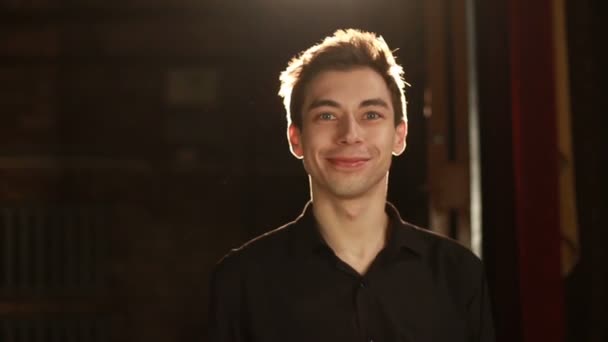 バックライトに対してOKジェスチャーと笑顔を示すハンサムな男背景 — ストック動画