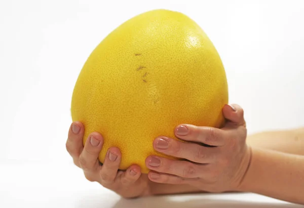 Woman hand with big yellow Pomelo. — Stock Photo, Image