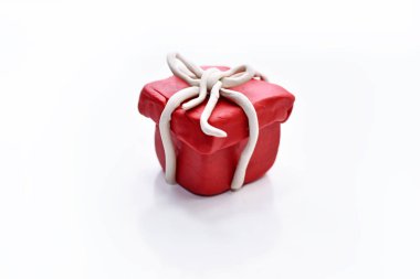Red present made from plasticine. clipart