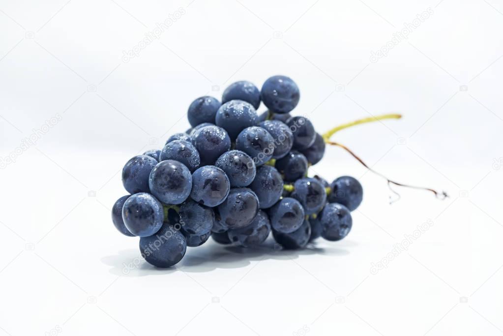 Raw dark grapes isolated on white background.