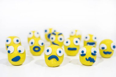 Abstract photo with yellow smileys made from Play Clay.