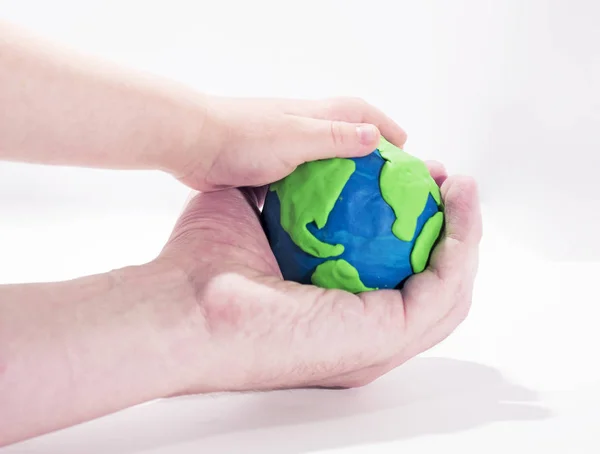 Small Earth model with human hands. — Stock Photo, Image