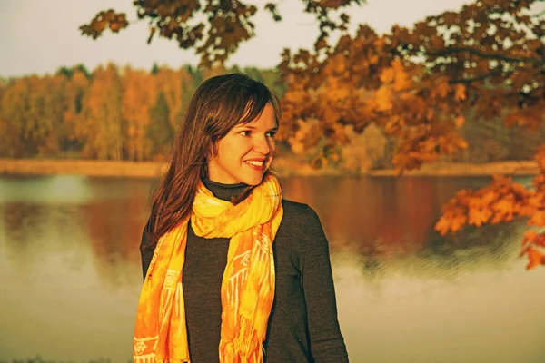 Retro styled photo. Young girl on lake coast. Sunny Autumn Day. — Free Stock Photo