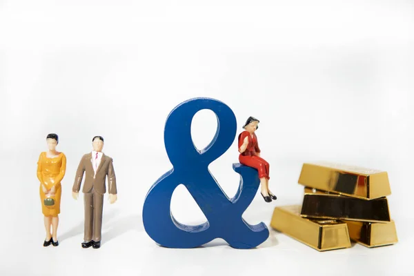Love triangle. Abstract photo of love and lovers. Big wooden letters with small plastic people figures.