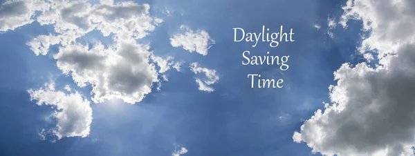 Daylight Saving Time (DST). Blue sky with white clouds and clock. Turn time forward (+1h). — Stock Photo, Image