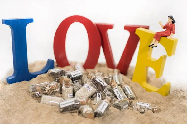 Glas-Reagenzglas mit Sand verschiedener Sommerurlaubsziele. Urlaubszeit abstraktes Foto. — Stockfoto