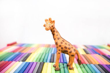 Play clay Animals. Giraffe on colored background.