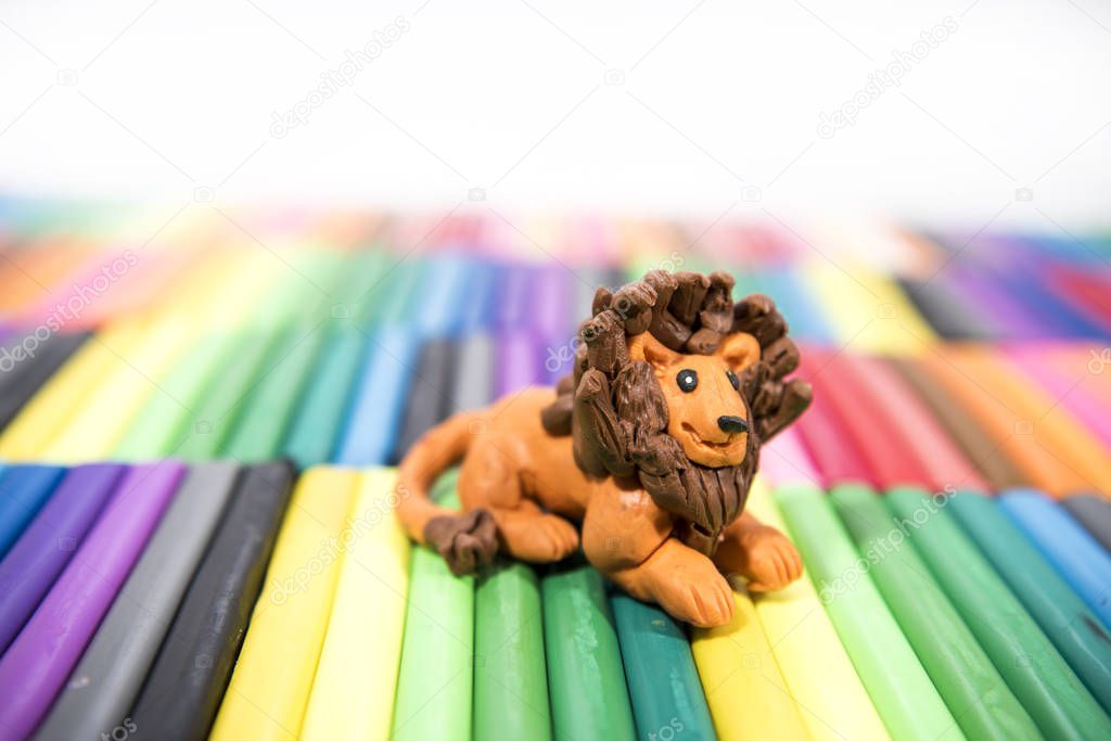 Play clay Animals. Leon on colored background.