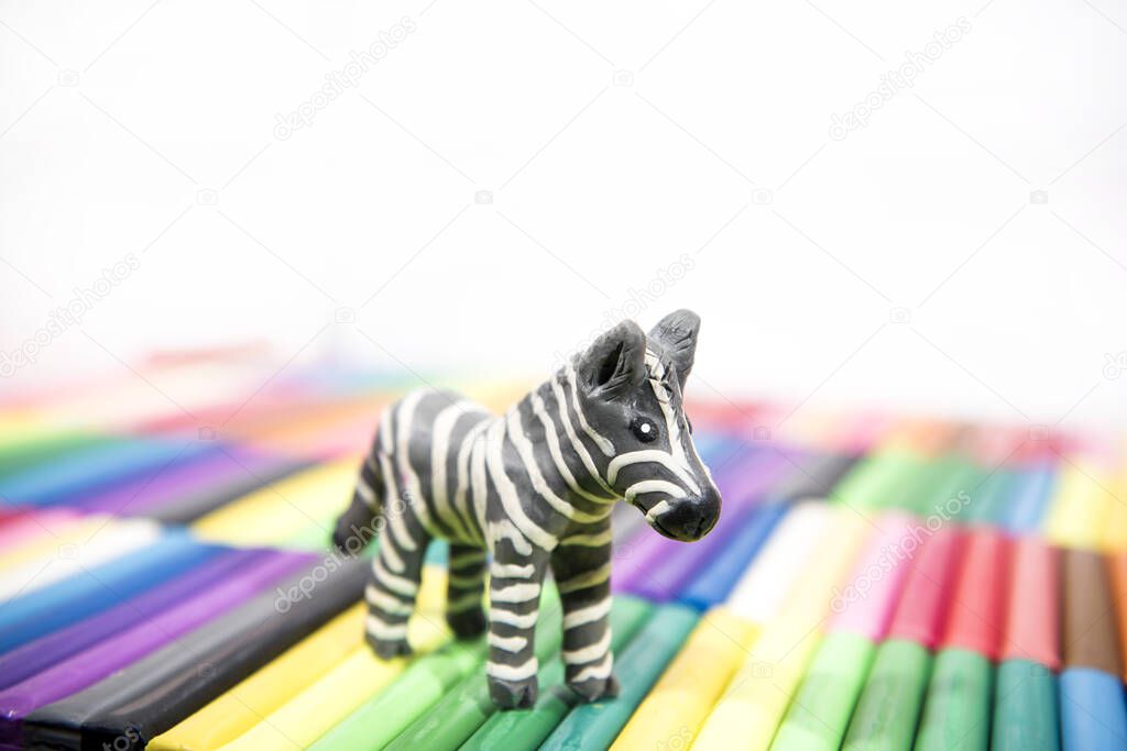 Play clay Animals. Zebra on colored background.