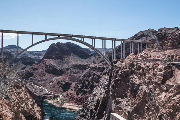 pedestrian bridge over a water dam in the desert of america