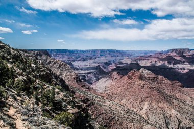 rocky crevice among the mountains of America under a blue sky covered with plants
