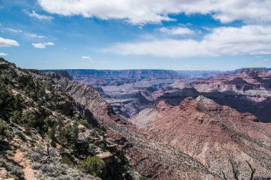 rocky crevice among the mountains of America under a blue sky covered with plants