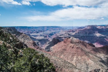 rocky crevice among the mountains of America under a blue sky covered with plants